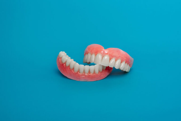 full set dentures, the top set on the bottom set with a blue background